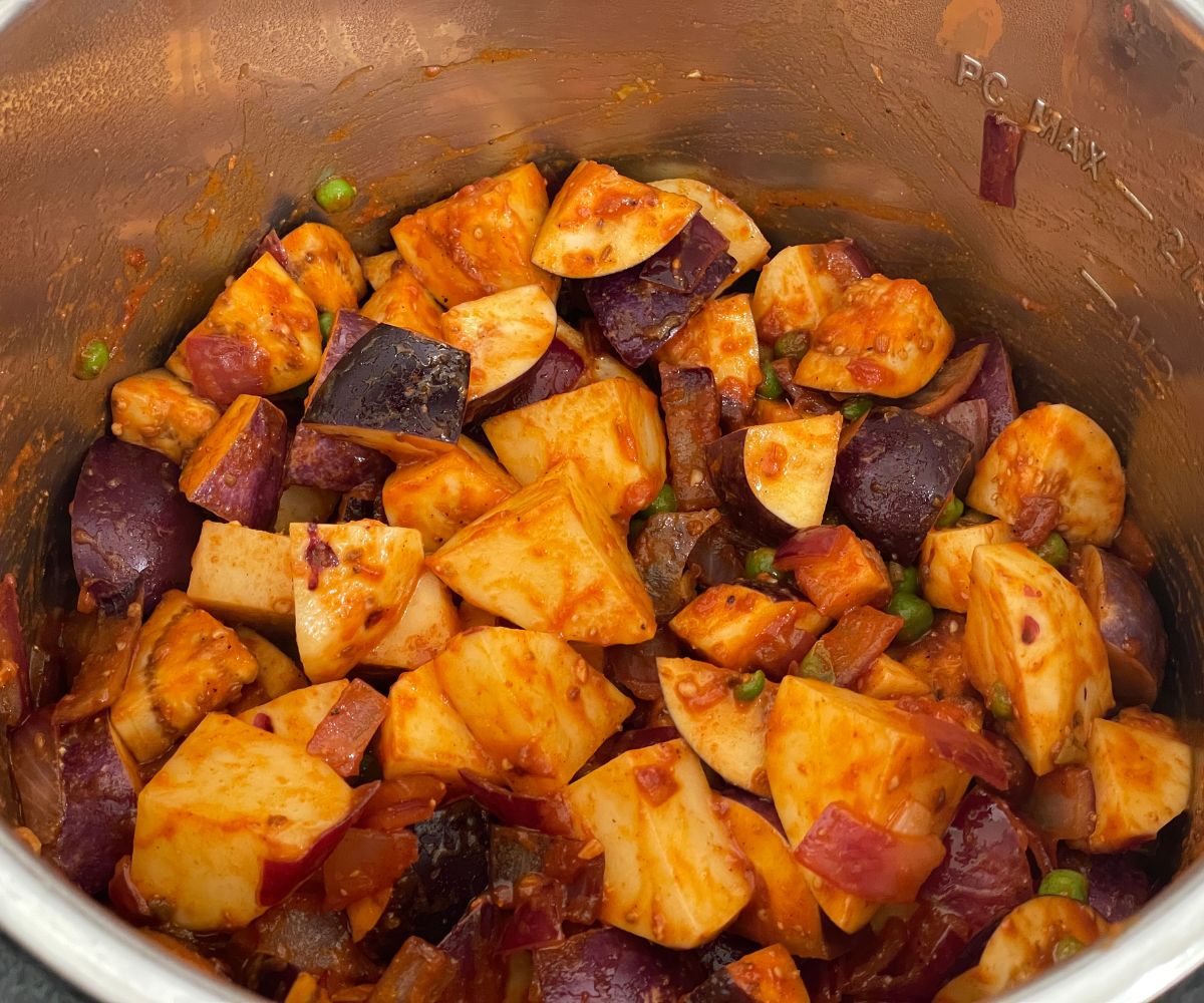 An instant pot is with eggplant curry mixture.