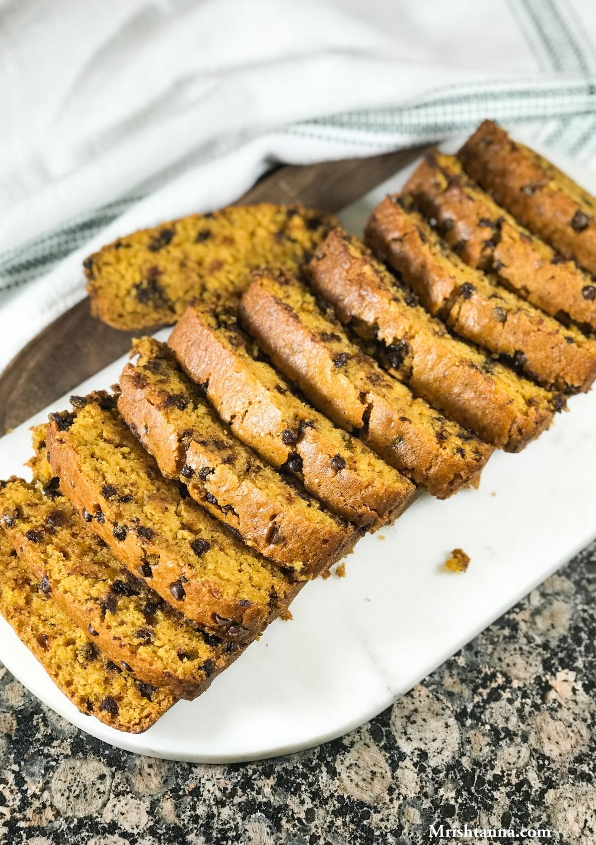 Vegan Pumpkin bread is sliced and placed on the white surface