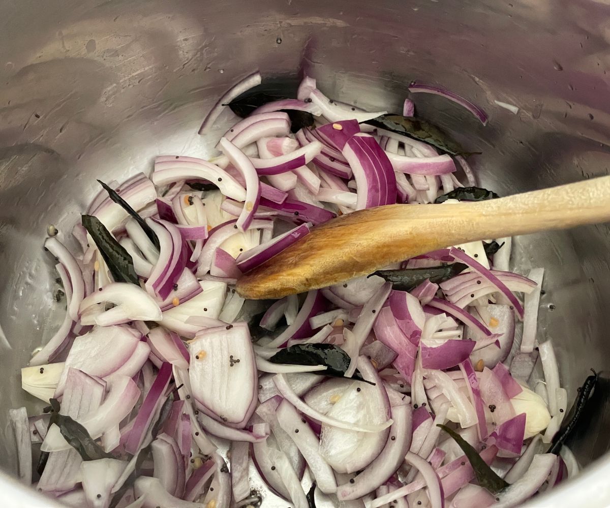 An instant pot has bisibelebath spices on the saute mode.