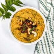 A bowl of bisi bele bhath is on the table.