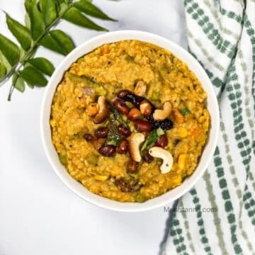 A bowl of bisi bele bhath is on the table.