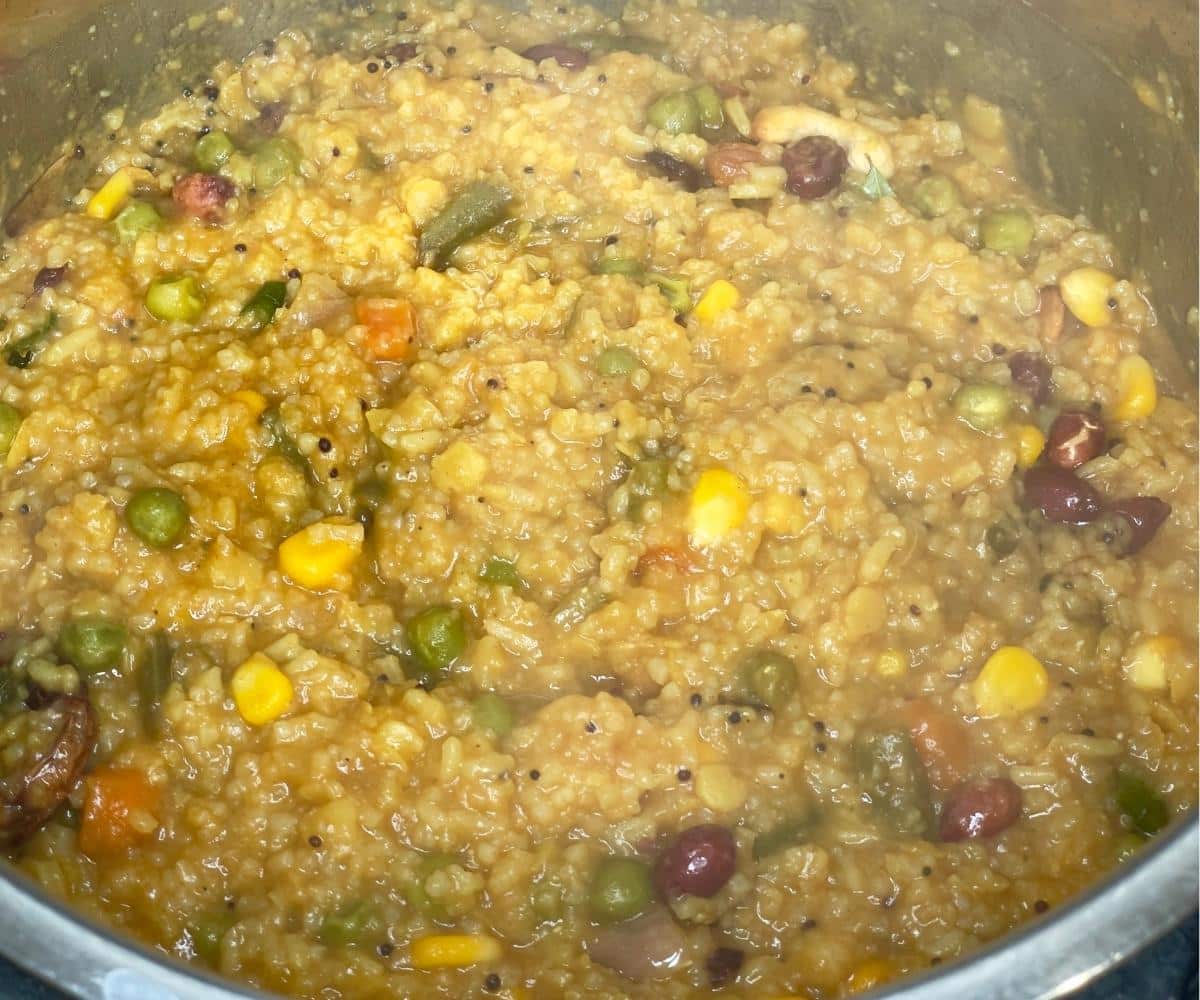 An instant pot is with cooked bisi Bele bath.