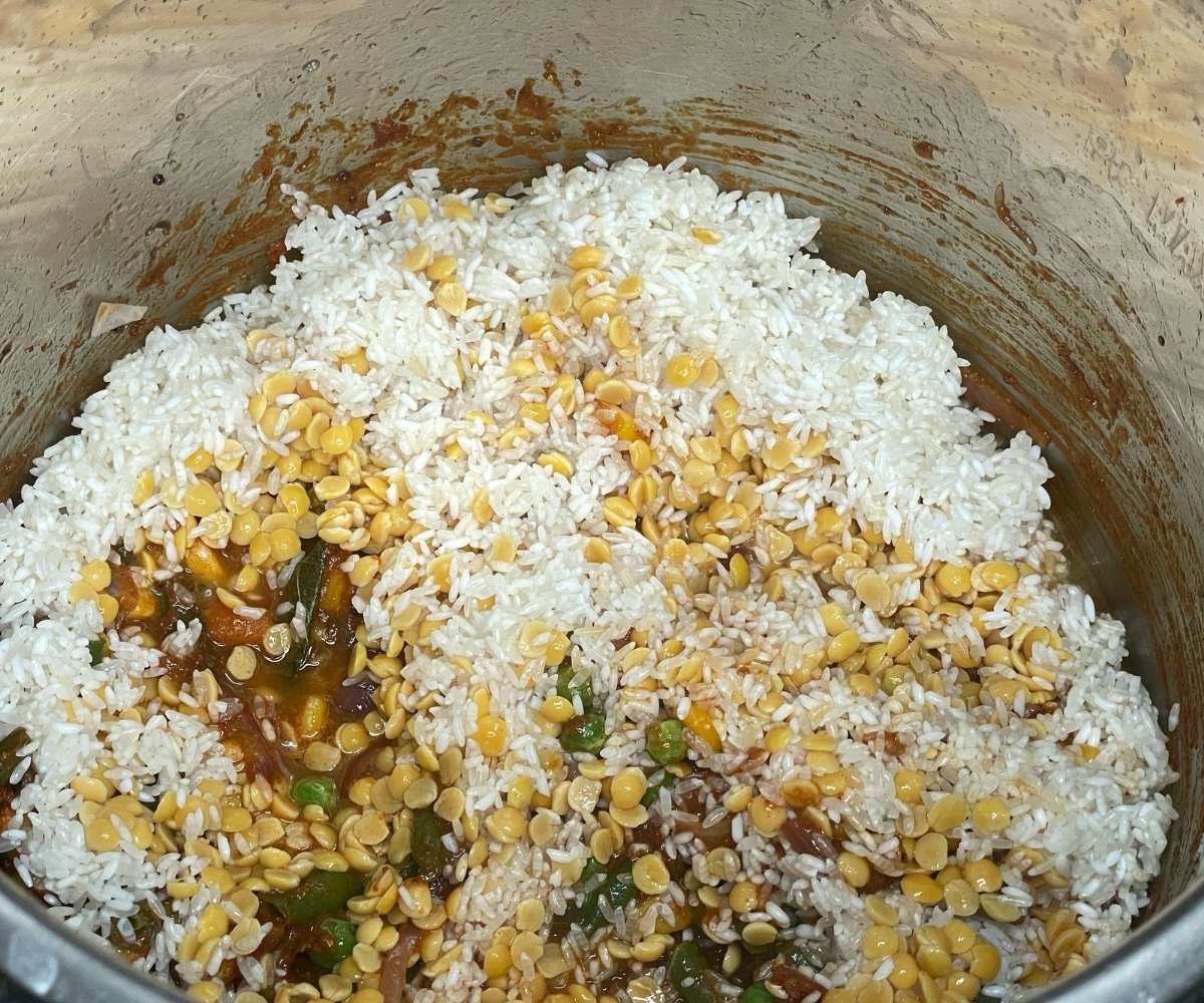 An instant pot is with spices, rice and lentils. 
