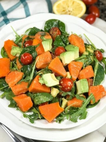 A plate of papaya salad is on the white surface