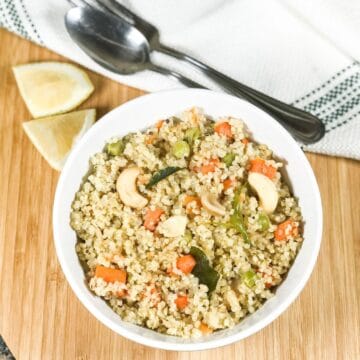 A bowl of quinoa and topped with cashew nuts