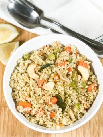 A bowl of quinoa and topped with cashew nuts