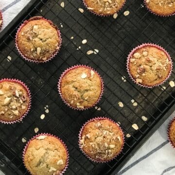 Banana oat muffins are placed on the cooling wire racks