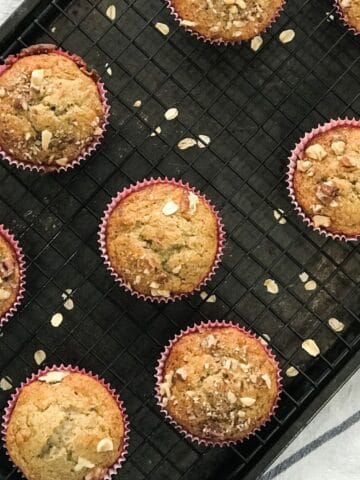 Banana oat muffins are placed on the cooling wire racks