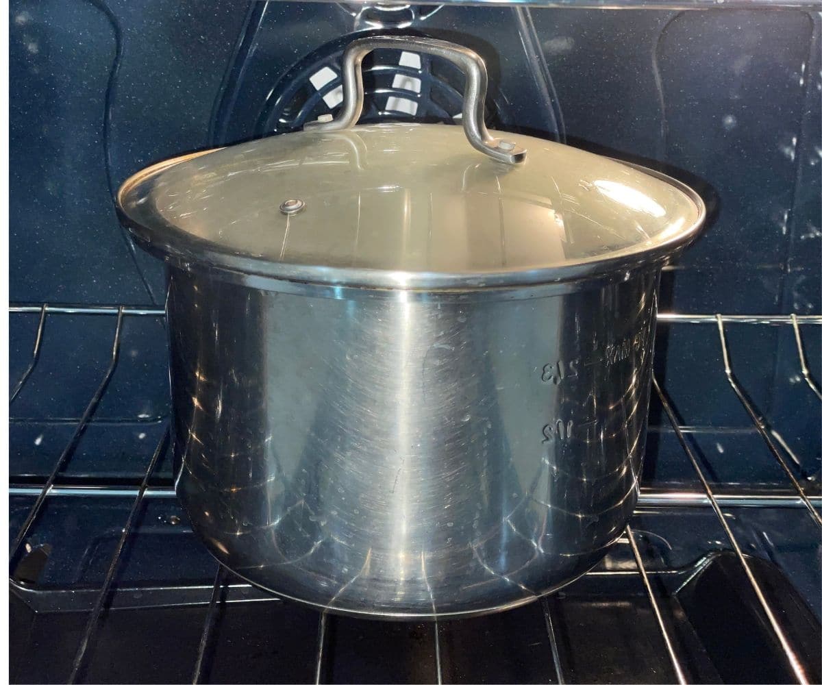 A Pot is with idli batter and placed inside the oven