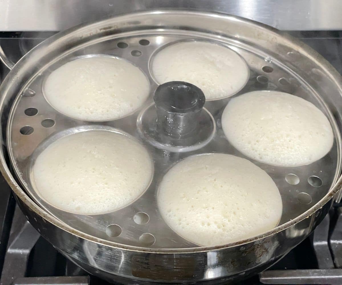 soft idli is inside the steamer.