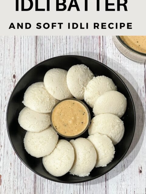 A plate of idli's are on the table along with chutney.