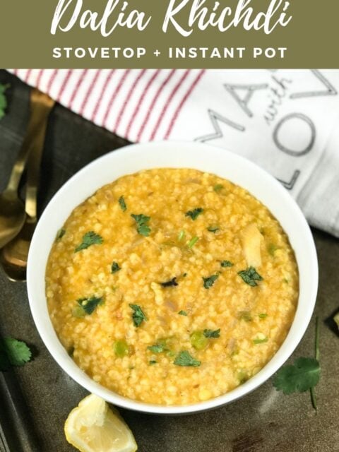 A bowl is with wheat khichdi and topped with cilantro