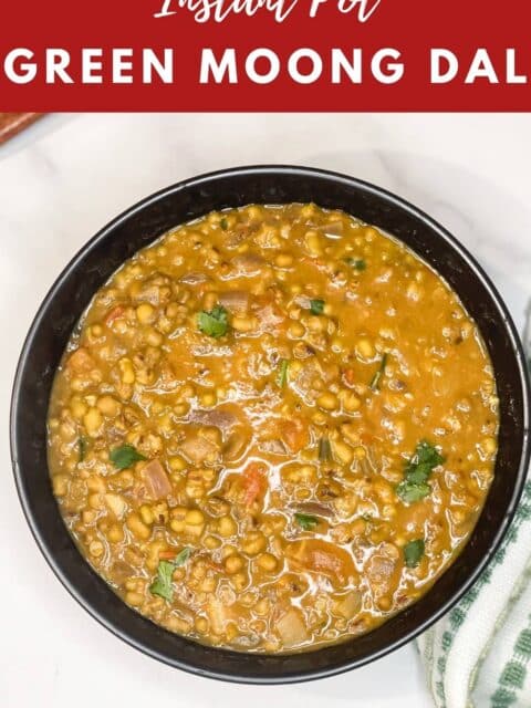A bowl of green gram dal is on the white surface.