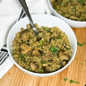A bowl is with mushroom quinoa is on the table