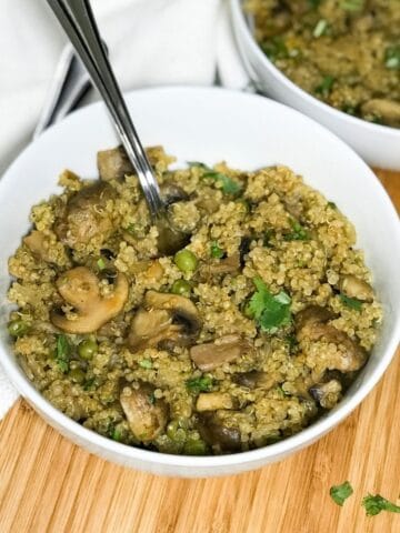 A bowl is with mushroom quinoa is on the table