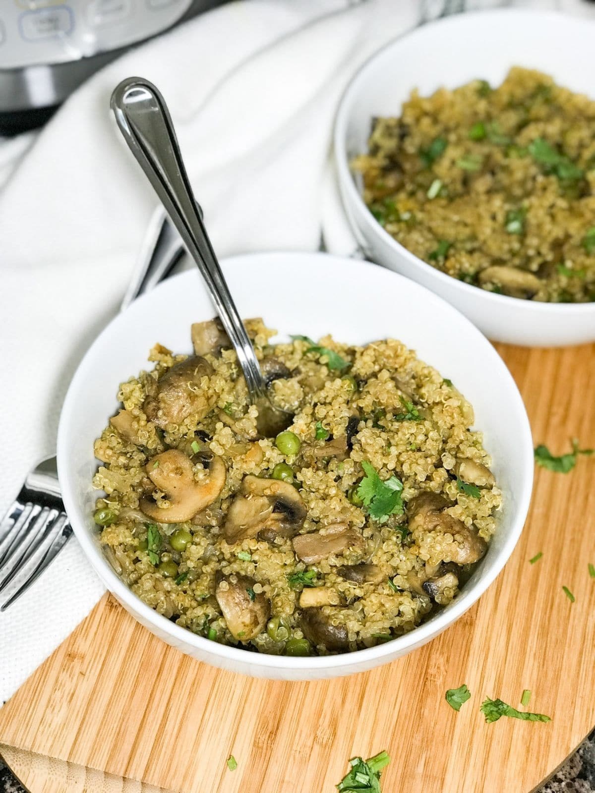 A bowl with mushroom quinoa is on the table