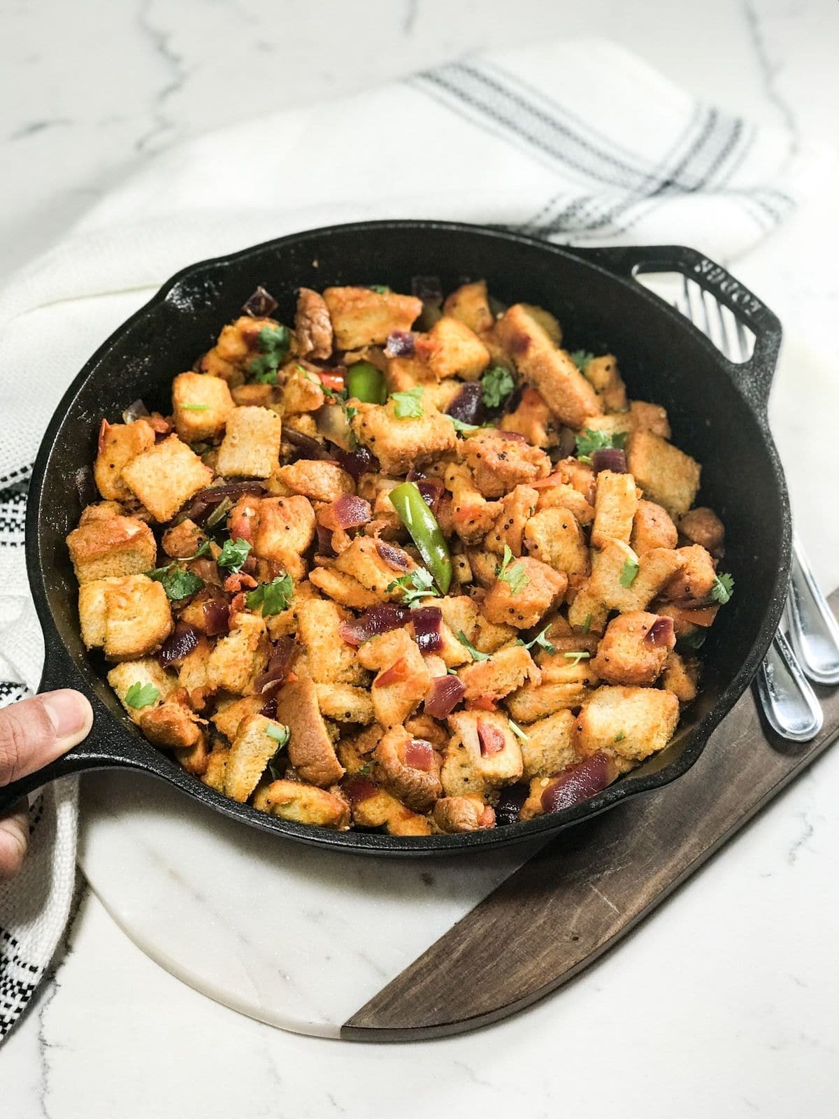 A pan is filled with bread upma it is on the table 