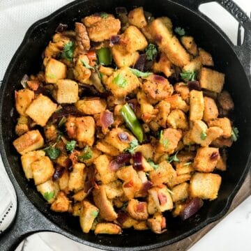 A cast iron pan is with bread upma