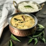 A bowl of aviyal curry is on the table