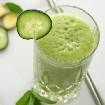Close up of a glass with cucumber smoothie on the table