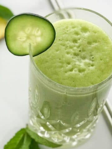 Close up of a glass with cucumber smoothie on the table