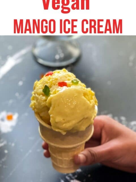 A cone is filled with mango ice cream