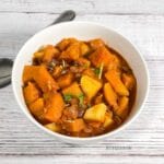 A close up of bowl with Indian pumpkin curry