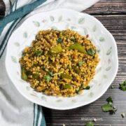 A plate is filled with sorghum upma placed on the table