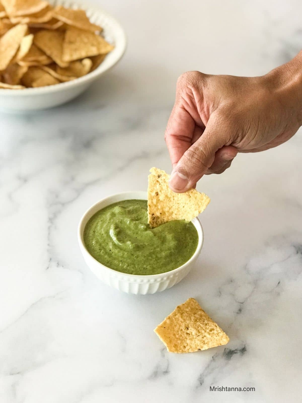 A small bowl is with jalapeno salsa on the table