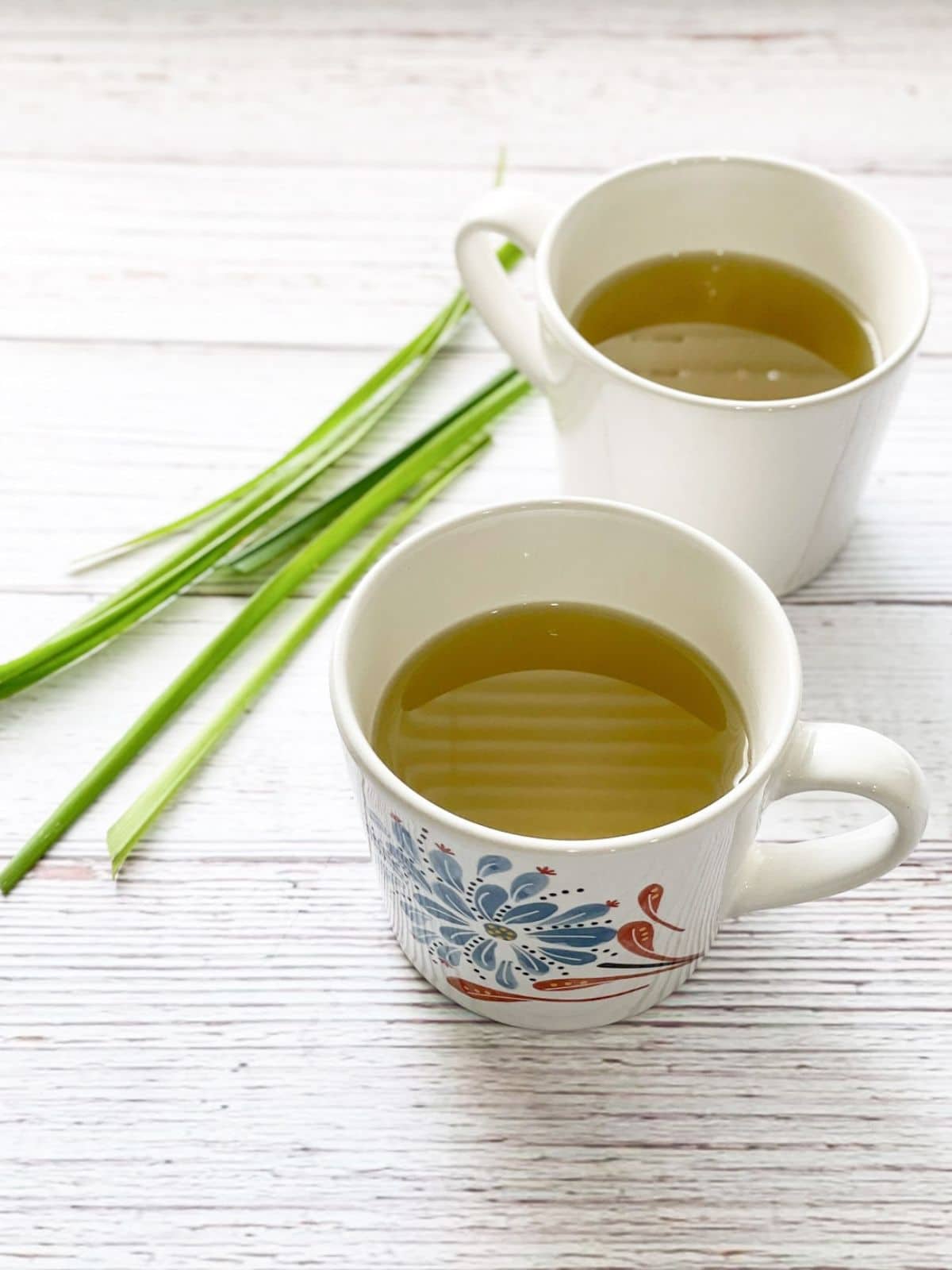 Two cups of lemongrass tea is on the table.