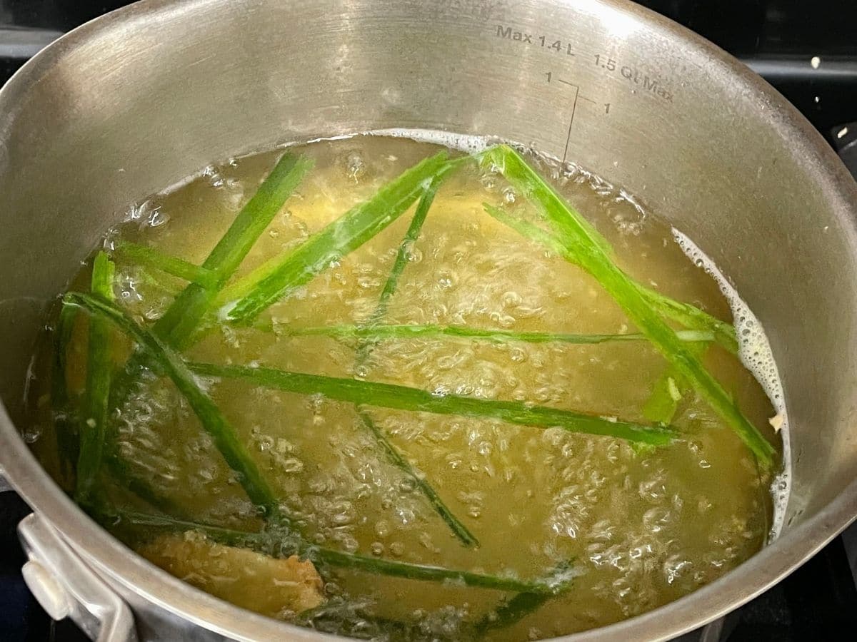 A boiling lemongrass tea is on the stove top.