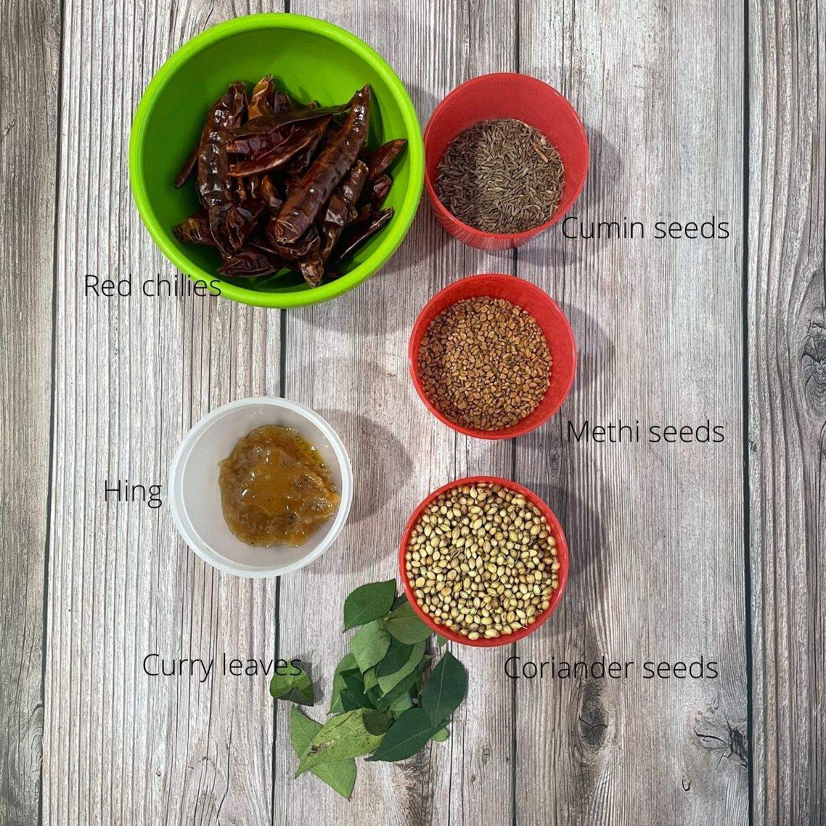 Bowls of rasam powder ingredients are on the table