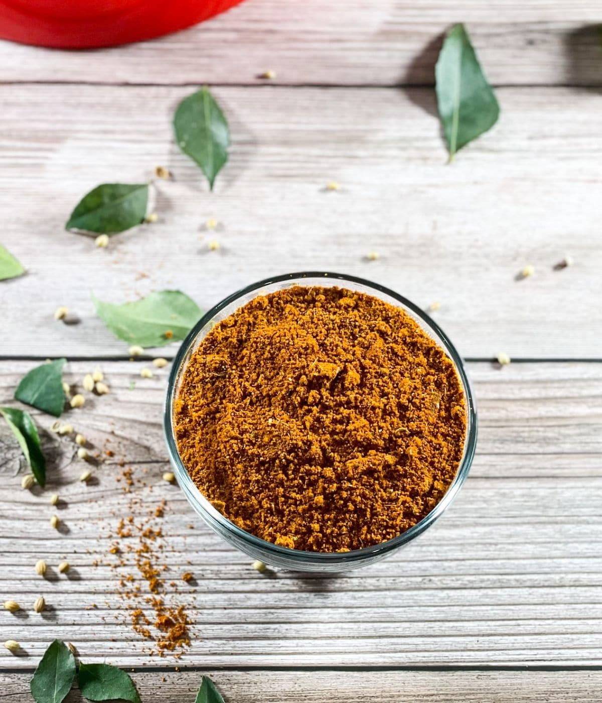 A bowl of rasam powder is on the table