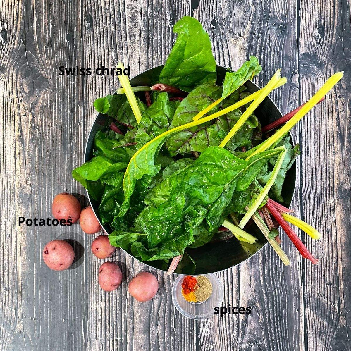 A bowl is with swiss chard and other ingredients for stir fry