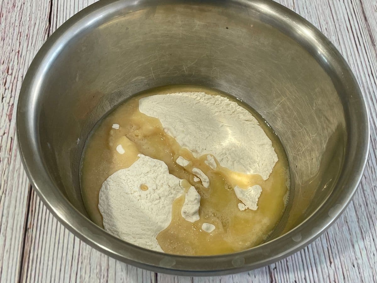 a bowl is with flour and oil for dough.