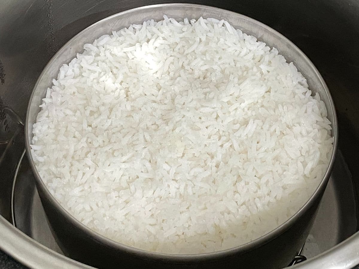 A small pot is with cooked Sona masoori rice.