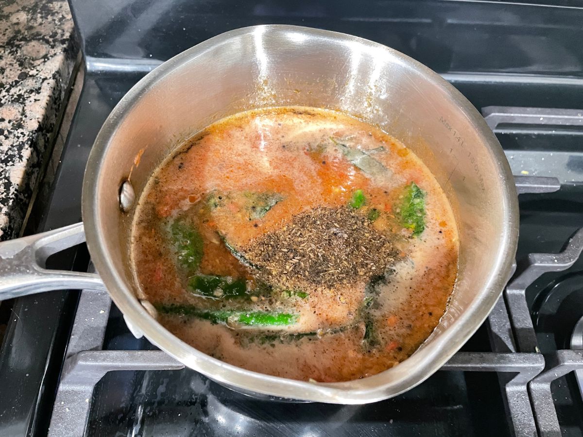 a small pot is with pepper rasam over the heat.