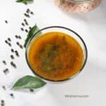 a bowl of pepper rasam is on the table