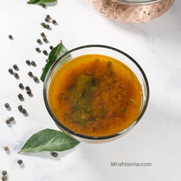 a bowl of pepper rasam is on the table