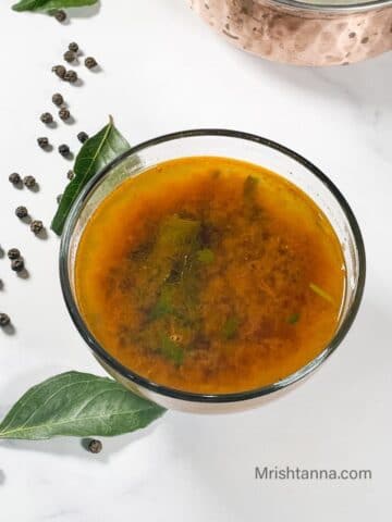 a bowl of pepper rasam is on the table