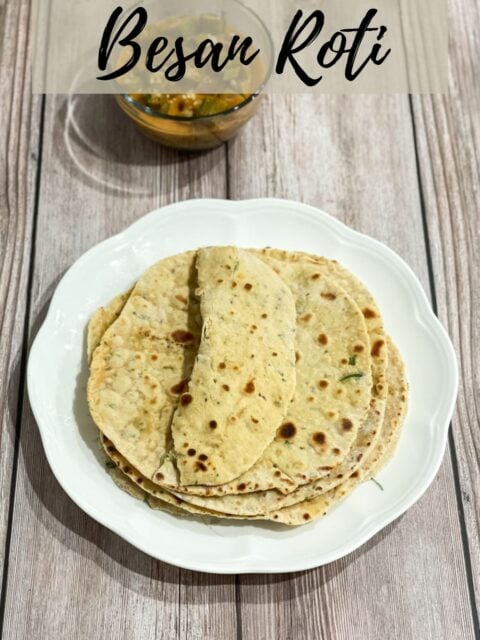 A plate of besan roti and bowl of curry is on the table