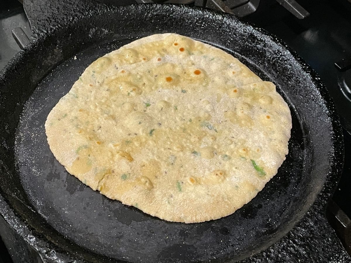 A hot tawa is with cooked besan roti