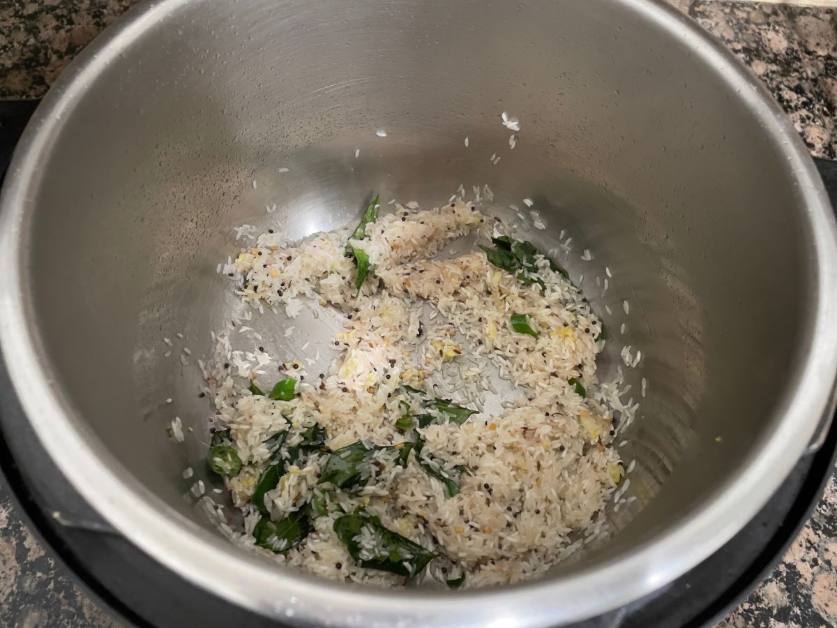 An instant pot is with rice and spices.