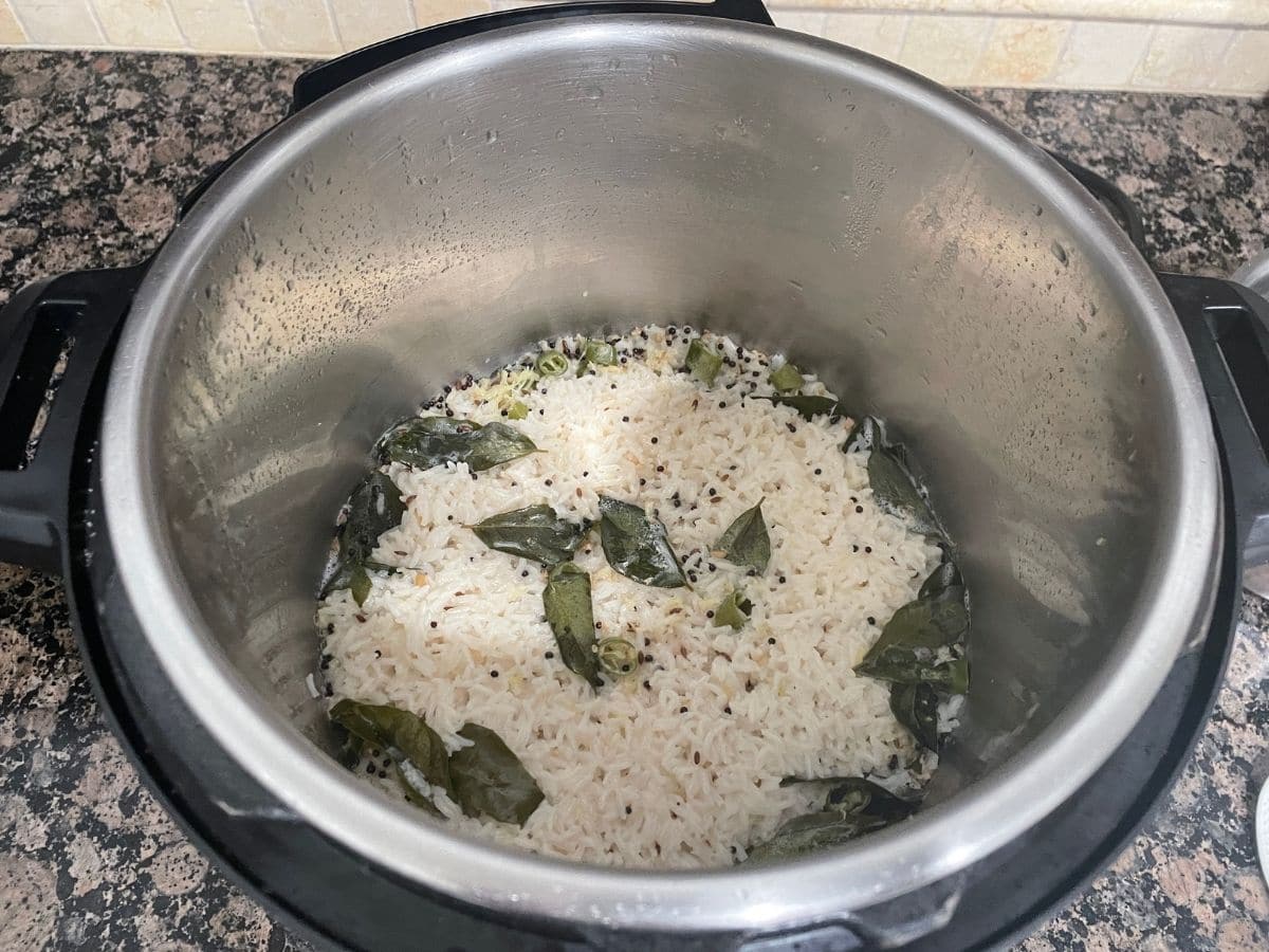 An instant pot is with coconut milk rice.