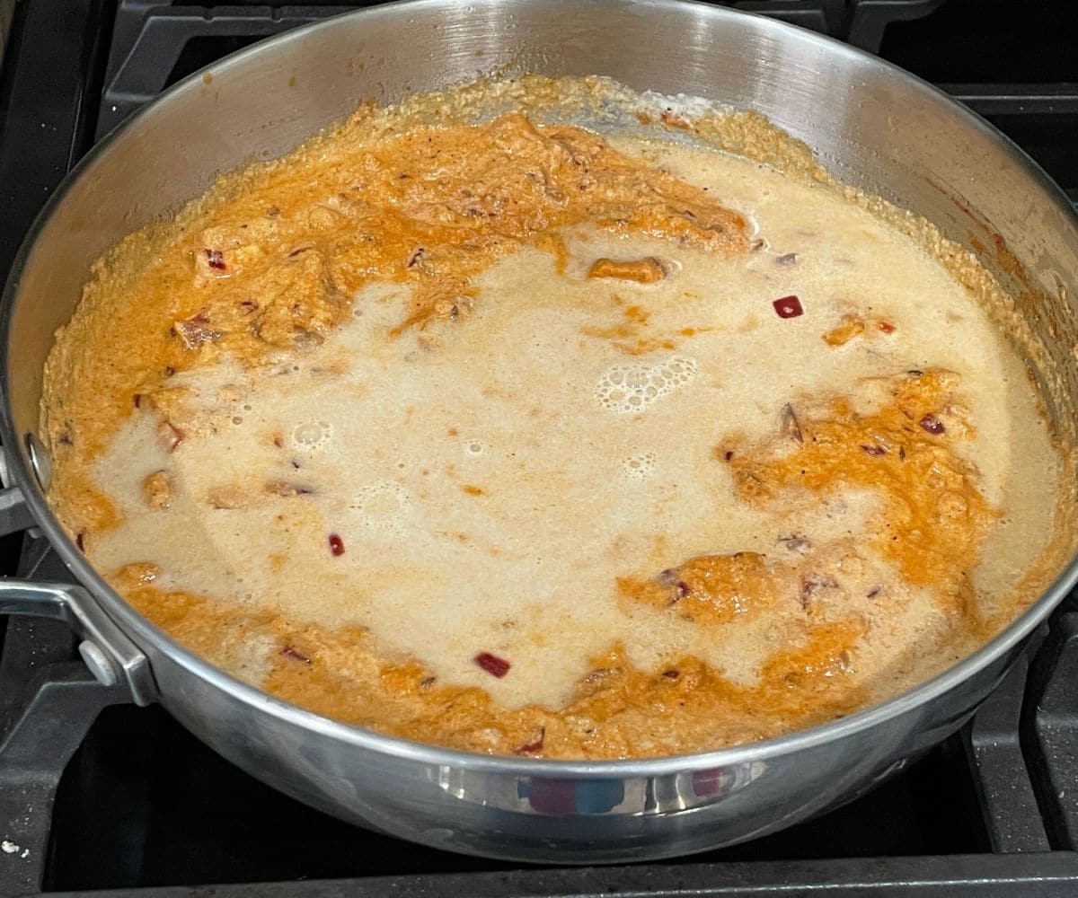 A pan is with cooked kurma gravy over the heat.
