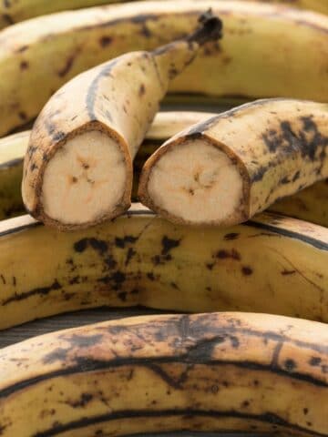 Ripe plantains divide in to half and placed on the whole plantains.