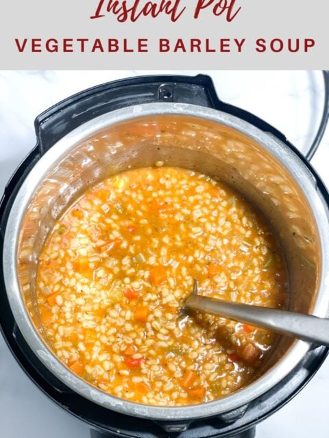 An instant pot is filled with vegetable barley soup and spoon is inserted.