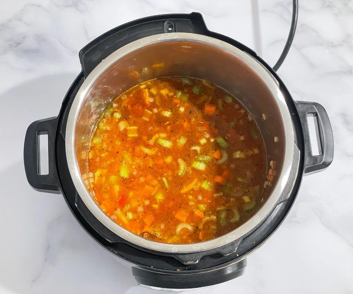 Pot is with vegetable barley soup on pressure cook mode.