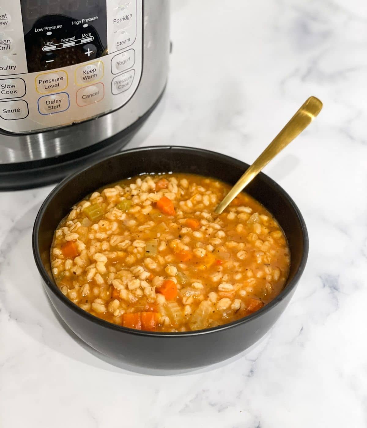 A bowl of barley soup is on the table.