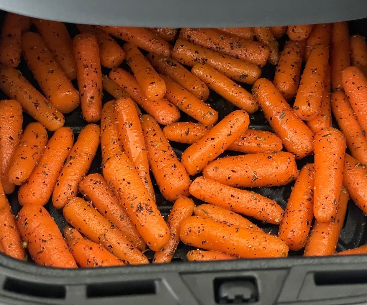 Air fryer is with baby carrots.